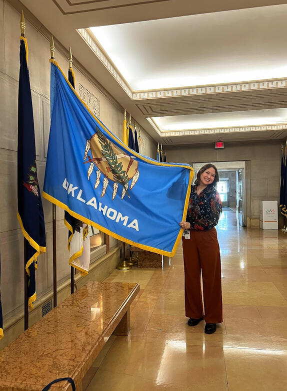 Grace with the Oklahoma flag in the Department of Justice